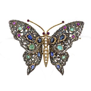 Gold and silver brooch with emeralds, rubies ... 