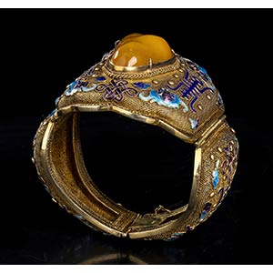 AN AMBER INLAID AND PARTIALLY ... 