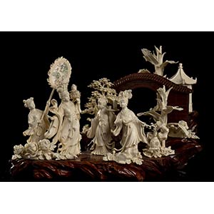 AN IVORY AND WOOD GROUP WITH FEMALE ... 