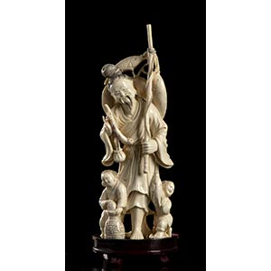 AN IVORY FISHERMAN WITH CHILDREN
China, ... 