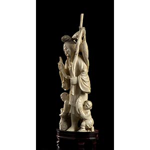 AN IVORY FISHERMAN WITH ... 