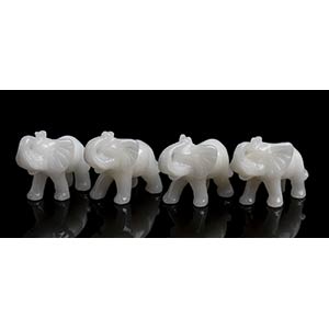 4 snow quartz carvingsdepicting elephants. ... 