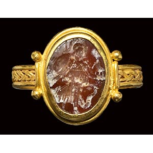 A late roman gold ring set with a burnt ... 