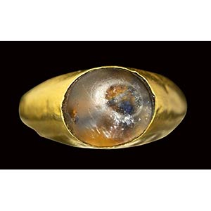 A roman gold ring set with a translucent ... 