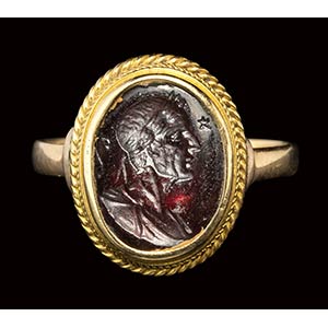 A garnet intaglio set in later gold ring. ... 