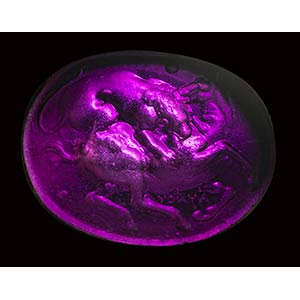 A dark purple glass impression set ... 