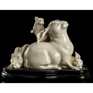A GLAZED PORCELAIN GROUP WITH THREE RABBITS ... 