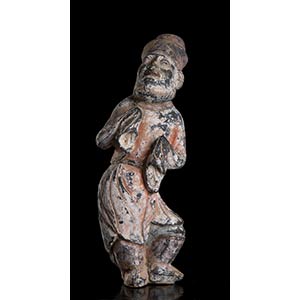 A PAINTED POTTERY FIGURE OF A BEARDED ... 