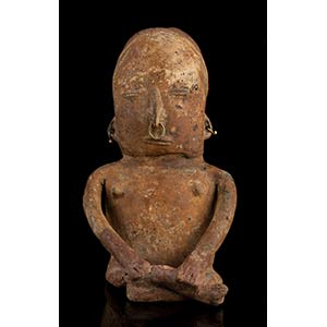 A POTTERY FIGURE WITH GOLD RINGS Colombia, ... 