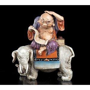 AN ENAMELLED PORCELAIN LOHAN ON AN ELEPHANT ... 