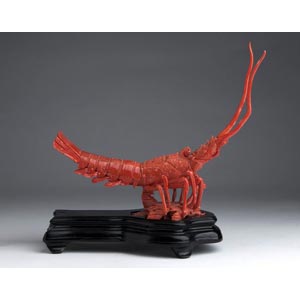 A carved coral sculpture depicting a Lobster ... 
