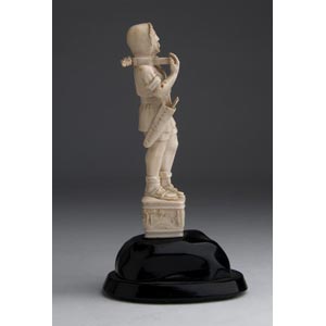 A carved ivory figure of a ... 