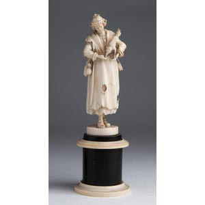 A carved ivory figure of a beggar ... 