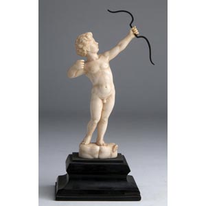 “Cupid”. A carved ivory figure depicting ... 