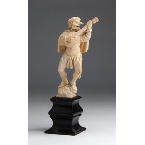 A carved ivory figure of a Minstrel - ... 