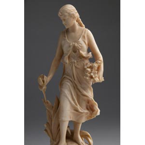 A carved ivory figure of a maiden ... 