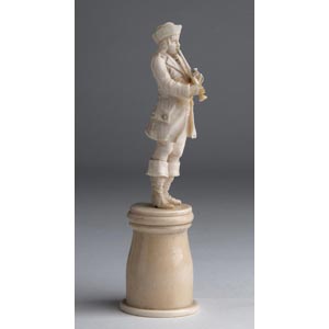 A carved ivory figure of musician ... 