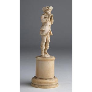 A carved ivory figure of musician ... 