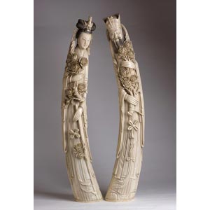 A pair of carved ivory figures of Emperor ... 