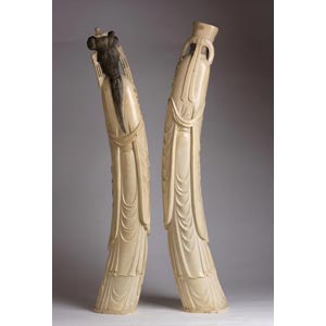 A pair of carved ivory figures of ... 