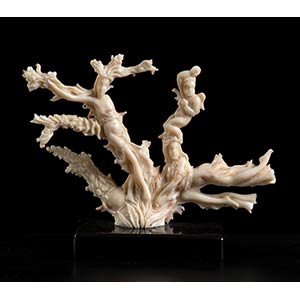 A PINK CORAL SCULPTURE WITH ... 