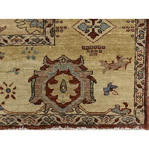 AN OCHRE GROUND CARPET WITH FLORAL ... 