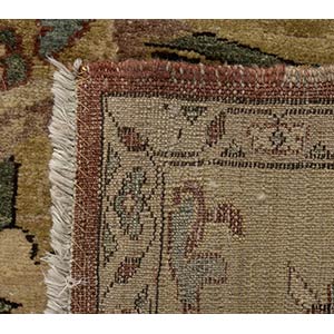 AN OCHRE GROUND CARPET WITH FLORAL ... 