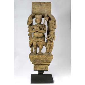 Wooden statue of crowned devote king with a ... 