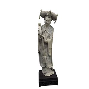 AN IVORY CARVING OF A STANDING ... 