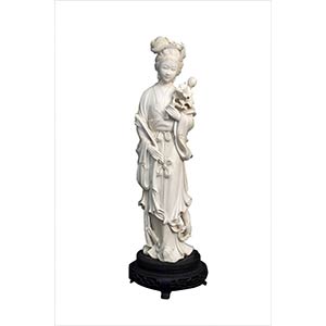 AN IVORY CARVING OF A STANDING LADYEarly ... 