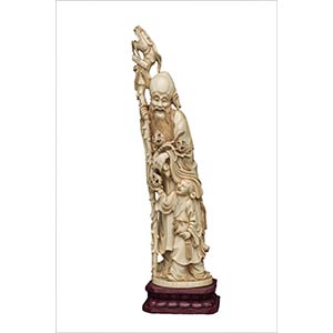 AN IVORY CARVING OF A STANDING SHOULAO Early ... 