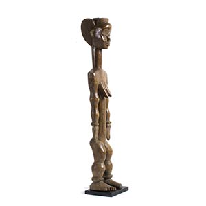 A DAN-YACUBA WOODEN FIGURE OF A STANDING ... 