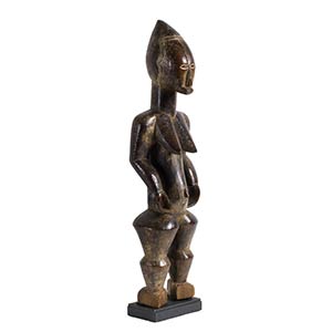 A BETE WOODEN FIGURE OF A STANDING ... 