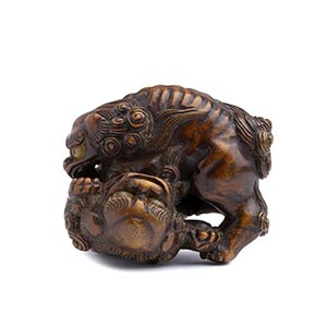 AN HORN INLAID WOOD NETSUKE OF TWO ... 