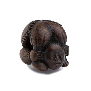 A WOOD NETSUKE OF A CONTORTIONIST19th ... 