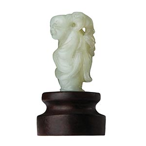 A PALE GREEN JADE CARVING OF A ... 