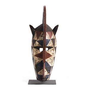 A WOODEN ZOOMORPHIC MASK, ... 