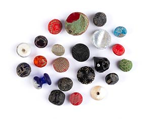 Group of twenty-two coloured glass buttons ... 