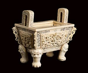A CARVED IVORY ARCHAISTIC ... 