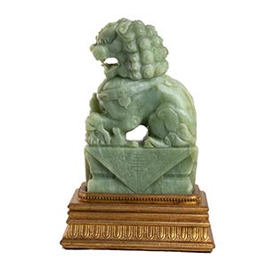 A CARVED GREEN HARDSTONE BUDDHIST ... 