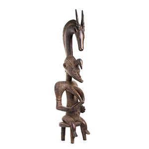 A WOOD FEMALE FIGURE WITH ANTELOPE FINIAL ... 