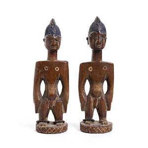 A PAIR OF YORUBA PAINTED WOOD ERE ... 