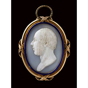 A shell cameo mounted in a gold and blu ... 