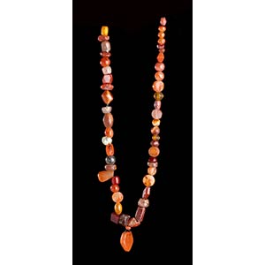 A CARNELIAN, OTHER STONES AND GLASS BEADS ... 