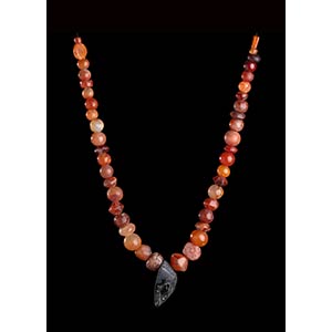 A CARNELIAN BEADS NECKLACE WITH STONE FACE ... 